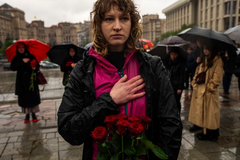 Family, friends and army comrades listen to Ukrainian national anthem during the funeral ceremony of Ukrainian army paramedic Nazarii Lavrovskyi, 31, killed in the war, at Independence square in Kyiv, Wednesday, April 24, 2024. Lavrovskyi, who served in the 244th battalion of the 112th Separate Territorial Defense Brigade, was killed April 18 while helping to evacuate wounded troops from the frontline in the Kharkiv area of eastern Ukraine. (AP Photo/Francisco Seco)