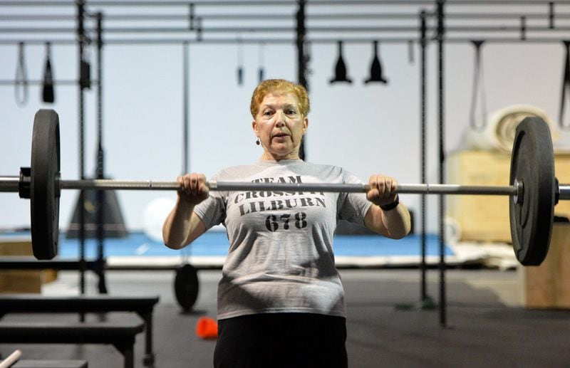 In this file photo, personal trainer Nancy Burnham lifts weights at a CrossFit in Lilburn. HYOSUB SHIN / HSHIN@AJC.COM