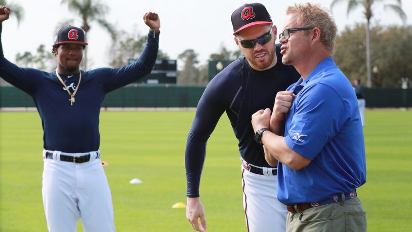 Atlanta Braves outfielder Ronald Acuna looks on while Freddie Freeman clowns around with Fox Sports Braves analyst Paul Byrd Tuesday, Feb. 19, 2019, during spring training at the ESPN Wide World of Sports Complex in Lake Buena Vista, Fla.