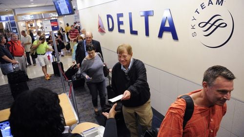Delta passengers board at Hartsfield-Jackson. (AP Photo/John Amis, file)