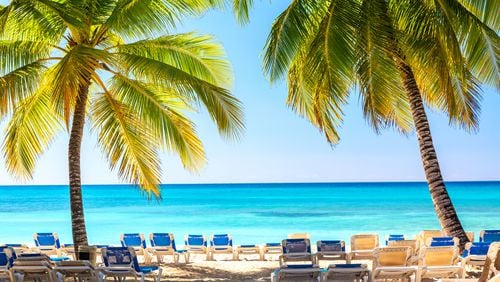 A beach with sun loungers and palms on Saona Island in the Dominican Republic.  (Nikolay Antonov/Dreamstime/TNS)