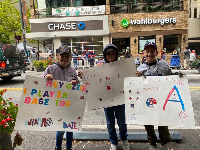 Olivia Rose, Channing Pittman, 10, and Cooper Rose, 11, with their homemade signs cheering on the Atlanta Braves Friday. Olivia and Cooper are grandchildren of AJC community contributor Cathy Lussiana.