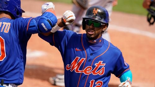 New York Mets' Francisco Lindor (12) is congratulated by Michael Conforto after scoring on a solo home run during the fifth inning Tuesday, March 23, 2021, against the Miami Marlins in Port St. Lucie, Fla. (Lynne Sladky/AP)