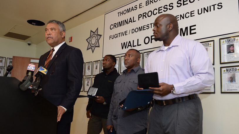 In this 2013 file photo, former DeKalb County Sheriff Thomas Brown (left) speaks at a press conference. )JOHNNY CRAWFORD / AJC)