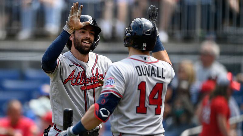 Braves shortstop Dansby Swanson (left) celebrates his two-run home run with teammate Adam Duvall (14) during the third inning Sunday, Aug. 15, 2021, against the Washington Nationals in Washington. (Nick Wass/AP)