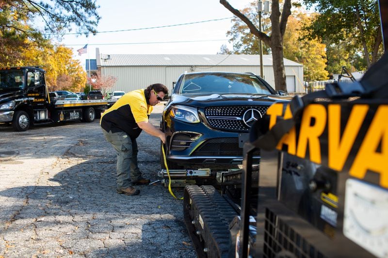 Syre Perkins, general manager at Tow Atlanta, shows off some of the technology the towing company uses at their Scottdale, Georgia, location on Thursday, November 21, 2019. Tow Atlanta has been investing in technology such as the TARVA, the Tow Atlanta Recovery Vehicle Autobot, to assist with safely towing both luxury and ordinary cars in Atlanta. (Photo/Rebecca Wright for the Atlanta Journal-Constitution)