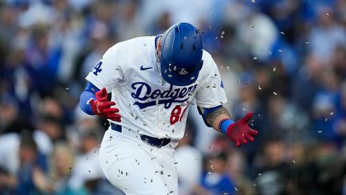Los Angeles Dodgers' Andy Pages is showered with sunflower seeds after hitting a home run during the fourth inning of a baseball game against the Atlanta Braves in Los Angeles, Saturday, May 4, 2024. The Braves lost 11-2. (AP Photo/Ashley Landis)