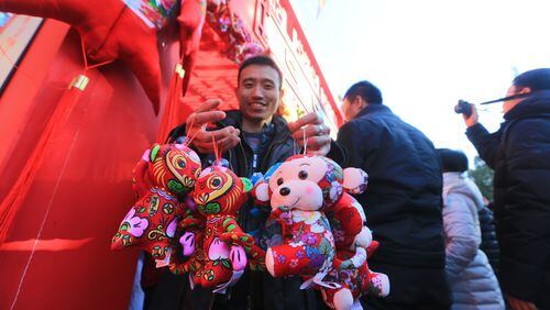 BEIJING, CHINA - FEBRUARY 08: (CHINA OUT) A man carries monkey toys during Ditan Temple (Temple of Earth Park) fair on first day of new Year of Monkey on February 8, 2016 in Beijing, China. Chinese people celebrate the Spring Festival for the new Year of Monkey, which fell on February 8 according to Chinese calendar. (Photo by ChinaFotoPress/ChinaFotoPress via Getty Images)