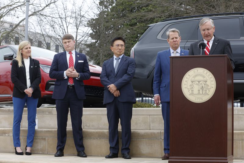 Marty Kemp, Pat Wilson, the Commissioner of the Georgia Department of Economic Development,  Kia America President and CEO Sean Yoon, Gov. Brian Kemp and Kia Georgia President and CEO Stuart Countess gather for the first ever Kia Day at the State Capitol on Tuesday, January 31, 2023. (Natrice Miller/The Atlanta Journal-Constitution) 