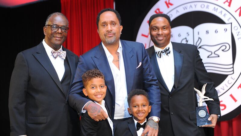 Clark Atlanta University President Ronald A. Johnson (left) poses for a photo with Kenya Barris (center) and his sons. On the right: National Alumni President Marshall Taggart. 