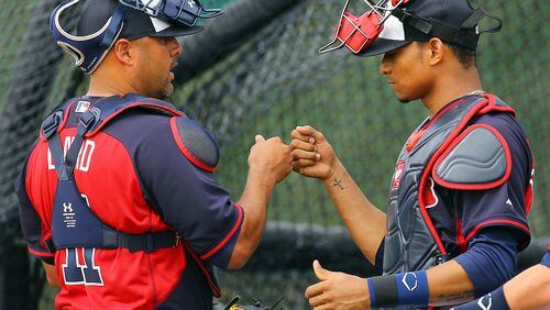 022114 LAKE BUENTA VISTA: Braves catchers Gerald Laird and Christian Bethancourt bump knuckles at the conclusion of catching drills during spring training on Friday, Feb. 21, 2014, in Lake Buena Vista, Fla. CURTIS COMPTON / CCOMPTON@AJC.COM