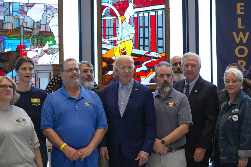 President Joe Biden, center, poses a group photo during his visit to United Steelworkers Headquarters, Wednesday, April 17, 2024, in Pittsburgh, Pa. (AP Photo/Alex Brandon)