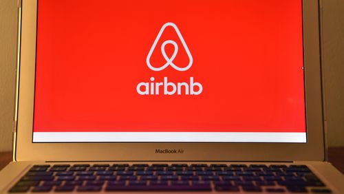 The Airbnb logo is displayed on a computer screen.