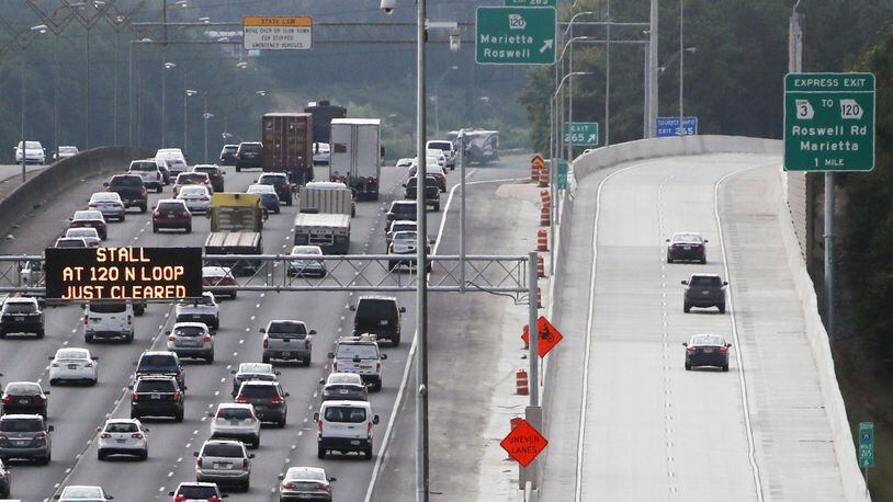 Southbound commuters on I-75 try the new Northwest Corridor Express Lanes as traffic backs up in Marietta Monday Morning. The lanes are free for the first two weeks (you still need a Peach Pass). After that, the minimum toll on the lanes for most of the day is 10 cents a mile. BOB ANDRES /BANDRES@AJC.COM