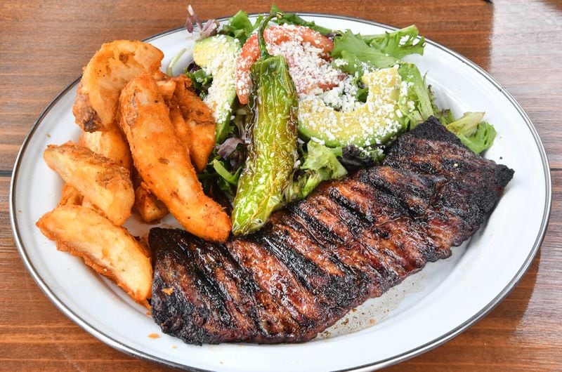 Antiguo Lobo's Carne Asada: fire-grilled skirt steak, papas (potatoes), mixed greens, chiles toreados. (Chris Hunt for The Atlanta Journal-Constitution)