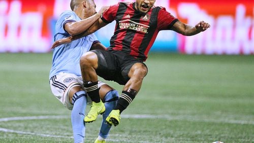 Atlanta United forward Josef Martinez and New York City midfielder Yangel Herrera collide battling for the ball during the first half in their MLS Eastern Conference Semifinal playoff match on Sunday, Nov. 11, 2018, in Atlanta.  Curtis Compton/ccompton@ajc.com