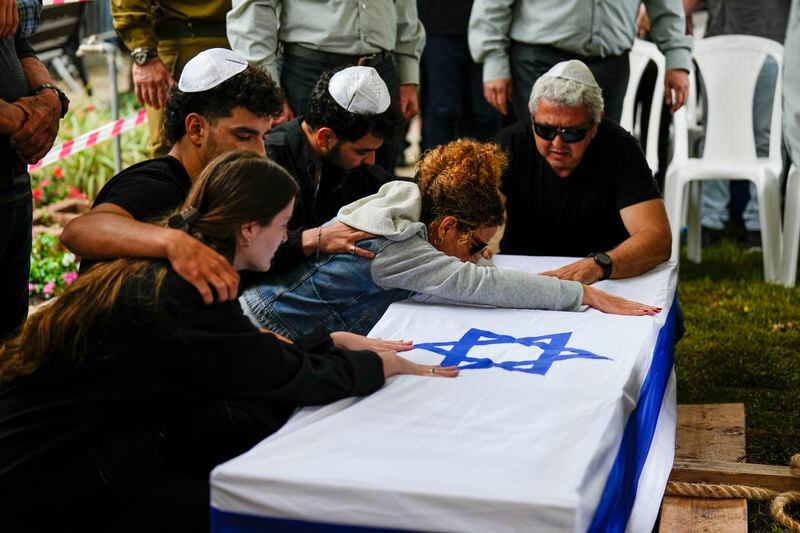 Ami Aviv mother of Israeli reserve soldier Master sergeant Ido Aviv kisses his casket during his funeral in Carmiel, northern Israel, Tuesday, April 30, 2024. Aviv, 28, was killed during Israel's ground operation in the Gaza Strip, where the Israeli army has been battling Palestinian militants in the war ignited by Hamas' Oct. 7 attack into Israel. (AP Photo/Ariel Schalit)