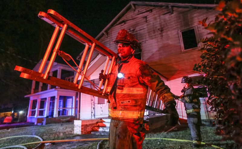 A firefighter was injured battling a house fire Friday at the corner of Mayson Turner Road and Joseph E. Lowery Boulevard. JOHN SPINK / JSPINK@AJC.COM