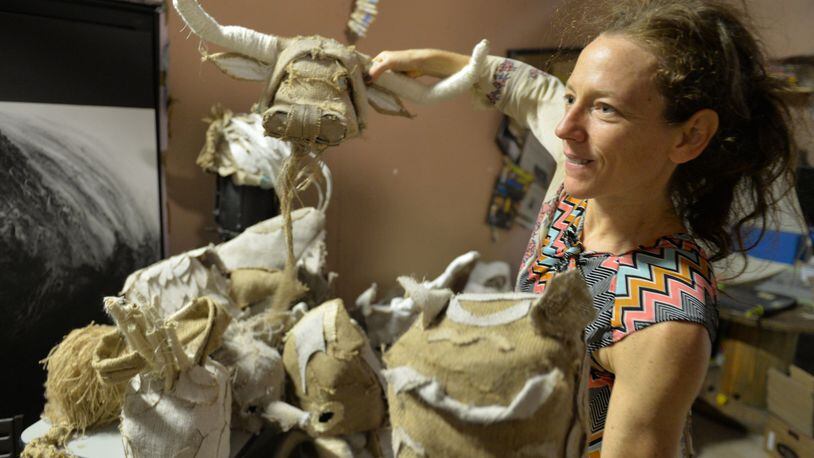 “Cloth” choreographer Lauri Stallings shows off some of the handmade animal mask dancers will wear during part of their performance at the Goat Farm in Atlanta. Brant Sanderlin/bsanderlin@ajc.com