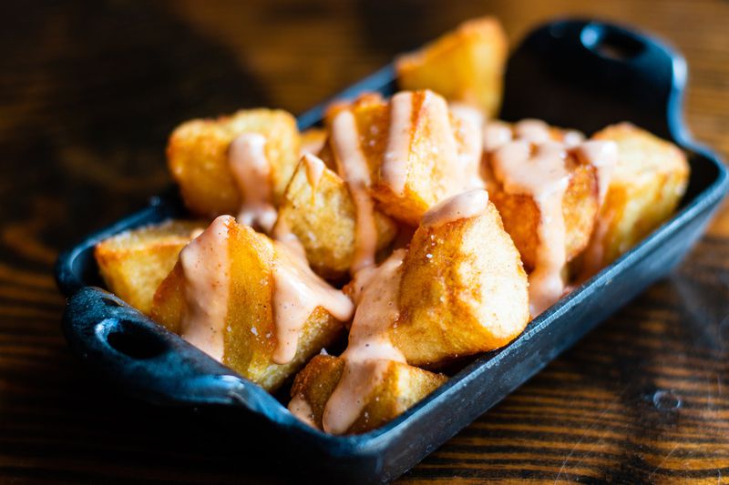 Under new chef Jay Swift, the Iberian Pig still dishes out classic tapas like these patatas bravas: twice-fried potatoes with pimenton aioli. CONTRIBUTED BY HENRI HOLLIS