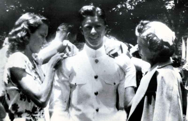At Jimmy Carter's graduation from the Naval Academy on June 5, 1946. His mother, Miss Lillian, and his fiancée, Rosalynn Smith, pin epaulets on Ensign Carter. (Credit: Jimmy Carter Library)