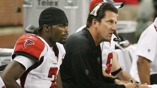 Falcons QB Michael Vick and offensive coordinator Greg Knapp sit on the bench in 2006.   (CURTIS COMPTON / AJC staff)