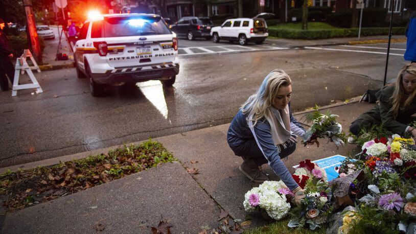 People place flowers near the Tree of Life Congregation, a day after 11 people died at the synagogue during a shooting rampage in Pittsburgh, Oct. 28, 2018. Georgia is one of 4 states without a hate crimes law. (Michael Henninger/The New York Times)