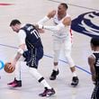 Dallas Mavericks' Luka Doncic (77) is fouled by Los Angeles Clippers' Russell Westbrook, right, during the second half of Game 2 of an NBA basketball first-round playoff series in Dallas, Friday, April 26, 2024. (AP Photo/Tony Gutierrez)