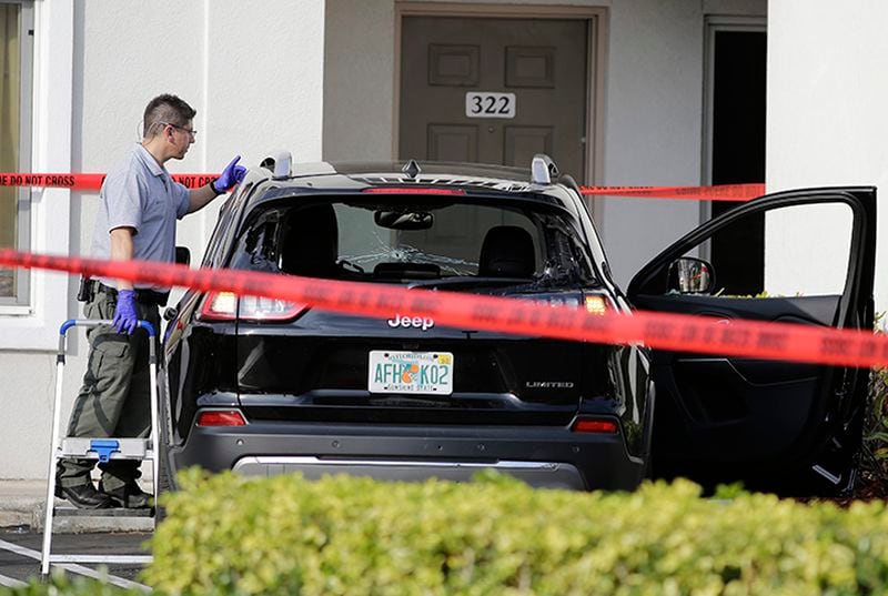 A forensic technician works on the vehicle authorities say officers fired shots at, that breached security at President Donald Trump's Mar-a-Lago resort in Palm Beach, Jan. 31, 2020, in West Palm Beach.