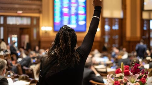 Rep. Park Cannon (D-Atlanta) raises her fist in protest as the House passes a measure that would have required drivers to learn "best practices" on how to interact with police during traffic stops on the final day of the 2021 Legislative session Wednesday, March 31, 2021. The bill ultimately failed. Ben Gray for the Atlanta Journal-Constitution