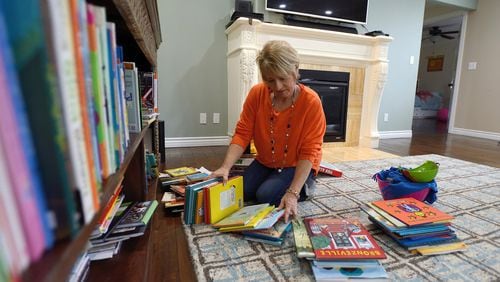 Don’t attempt to organize your belongings before getting rid of the clutter, say professional organizers. Home de-clutterer Dorothy Breininger works to organize children’s books in the home of a client in Ladera Heights, Calif. (Jeff Gritchen/Orange County Register/TNS)