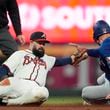 Texas Rangers' Evan Carter is tagged out by Atlanta Braves second base Luis Guillorme as he attempts to steals second base in the seventh inning of a baseball game Sunday, April 21, 2024, in Atlanta. (AP Photo/John Bazemore)