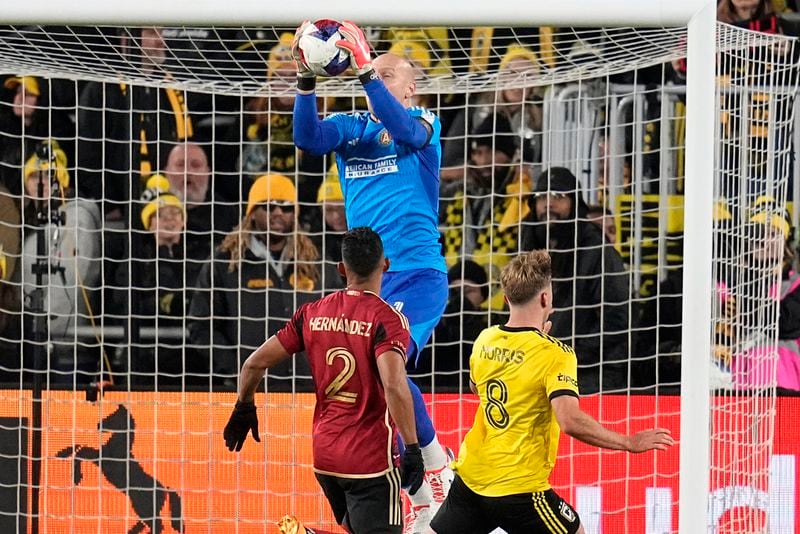 Atlanta United's Brad Guzan, rear, makes a save behind United's Ronald Hernández (2) and Columbus Crew's Aidan Morris (8) during the first half of an MLS playoff soccer match Wednesday, Nov. 1, 2023, in Columbus, Ohio. (AP Photo/Sue Ogrocki)