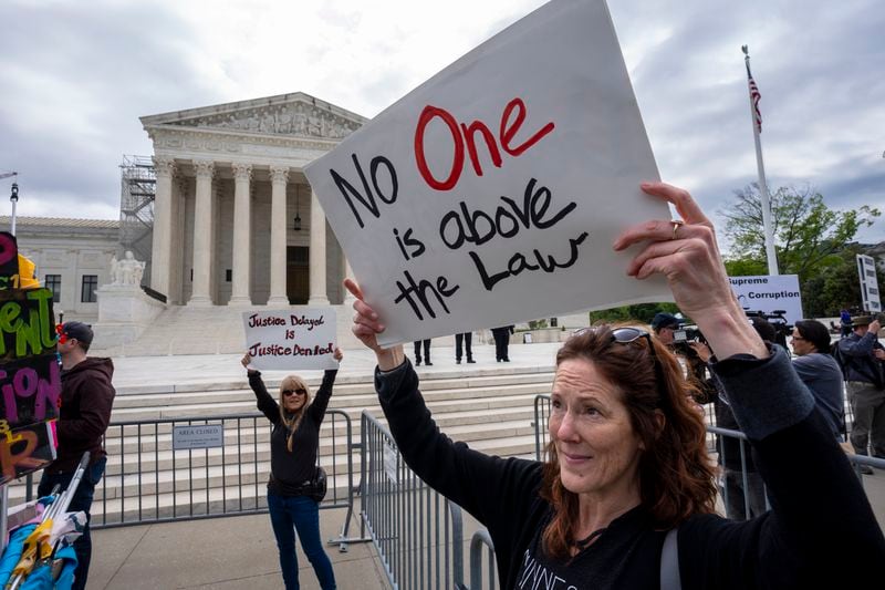 Diana Neary of Minneapolis, joins other protesters demonstrating outside the Supreme Court as the justices hear arguments over whether Donald Trump is immune from prosecution in a case charging him with plotting to overturn the results of the 2020 presidential election, on Capitol Hill in Washington, Thursday, April 25, 2024. (AP Photo/J. Scott Applewhite)