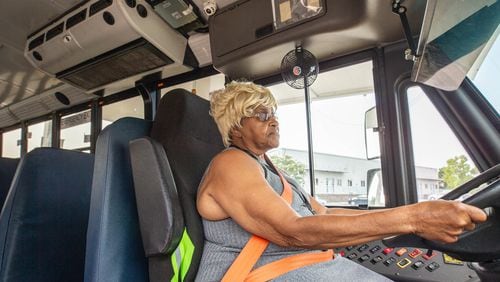 Clayton County school bus driver Ruby White poses for a photograph with the new AC units that have been put into the buses Friday, Aug. 25, 2023. (Katelyn Myrick/katelyn.myrick@ajc.com)