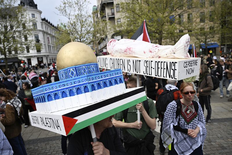 Protestors carry a model of the Dome of the Rock during a Stop Israel demonstration, between Stortorget and Mölleplatsen in Malmö, Sweden, Thursday, May 9, 2024. There have been calls for Israel to be excluded from the Eurovision Song contest because of its conduct in its war against Hamas. (Johan Nilsson/TT News Agency via AP)