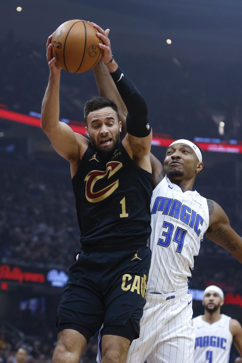 Cleveland Cavaliers guard Max Strus (1) rebounds against Orlando Magic center Wendell Carter Jr. (34) during the first half of Game 5 of an NBA basketball first-round playoff series, Tuesday, April 30, 2024, in Cleveland. (AP Photo/Ron Schwane)