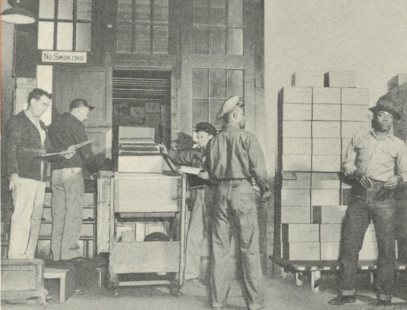 Tom's employed Columbus residents of all stripes. However, at midcentury, the work was strictly segregated by both race and gender. Here, two Black male laborers can be seen at right, with white male shipping clerks at left. (Courtesy of Collection of the Columbus Museum, Georgia. Published with permission.)