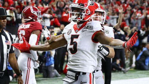 Georgia defensive back Kelee Ringo celebrates his pick six in the College Football Playoff Championship game on Jan. 10 in Indianapolis.  (Curtis Compton / Curtis.Compton@ajc.com)
