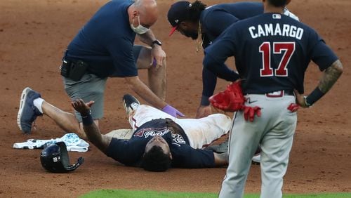 Braves outfielder Cristian Pache lays on the ground after suffering an injury on Monday, July 13, 2020 in Atlanta. (Curtis Compton/Atlanta Journal-Constitution)