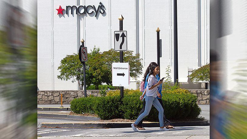 People walk by a sign indicating the direction to the Lenox Square Mall's entrance Monday, May 4, 2020. STEVE SCHAEFER / SPECIAL TO THE AJC