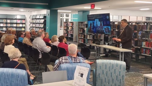 Retired Cobb County librarians James Camp (right) volunteers his expertise to present programs around history and culture.