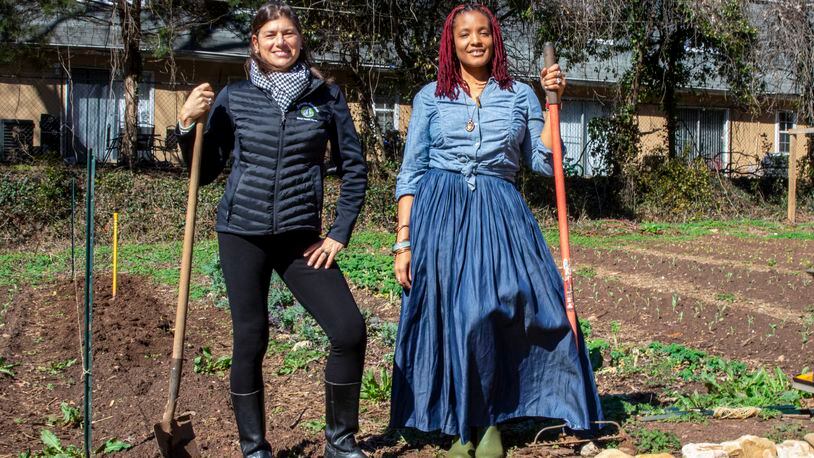 Leslie Zinn (left), CEO of Arden's Garden, and Yennenga Adanya, founder of Oyun Botanical Gardens, partnered to keep the urban farm located in East Point from being purchased and redeveloped. (Courtesy of Arden's Garden)