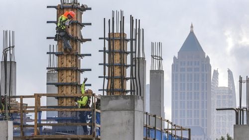 Construction workers on July 10, 2019 continued work on The Interlock, a $450 million mixed-use development in West Midtown that commercial real estate development firm, S.J. Collins Enterprises is overseeing. JOHN SPINK/JSPINK@AJC.COM