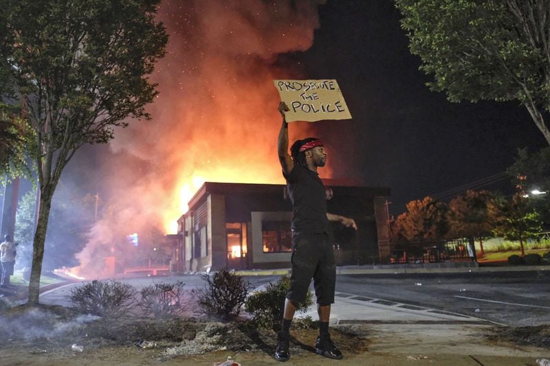June 13, 2020 - Atlanta - Wendy’s in flames, after demonstrators blocked the interstate and set it on fire. Protestors gather at University Ave. at the Atlanta Wendy’s where Rayshard Brooks, a 27-year-old Black man, was shot and killed by Atlanta police Friday evening during a struggle in a Wendy’s drive-thru line. Ben Gray for the Atlanta Journal Constitution