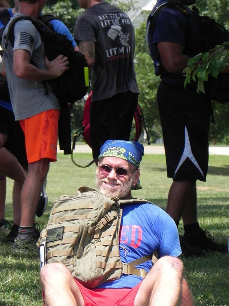 John Tackett does some PT at a rucking event, crab-walking with his weighted rucksack on top of his chest. CONTRIBUTED: JASON TACKETT