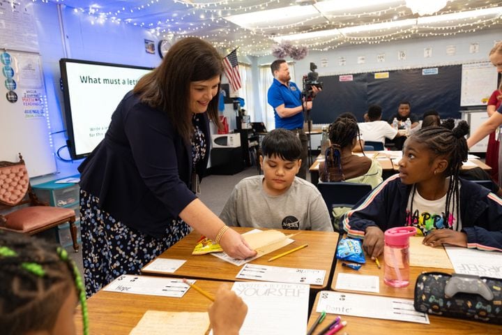 Compton Elementary School Principal Beth Lair looks over Charlie Vega’s letter to his future self on the first day of class Tuesday, Aug. 1, 2023, in Powder Springs.   (Ben Gray / Ben@BenGray.com)