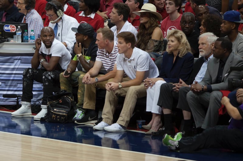 Boxer Floyd Mayweather, far left, Ted Turner and Atlanta Mayor Kasim Reed, on the right, were among the famous fans cheering on the Hawks last night. Photo: August Heim
