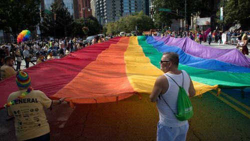 A giant rainbow flag makes its way down Peachtree St. during the Atlanta Pride Parade Sunday in Atlanta GA. October 14, 2018. STEVE SCHAEFER / SPECIAL TO THE AJC