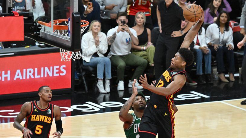 Hawks forward De'Andre Hunter (12) dunks against the Boston Celtics during the first half in Game 4 of the first round of the Eastern Conference playoffs at State Farm Arena, Sunday, April 23, 2023, in Atlanta.